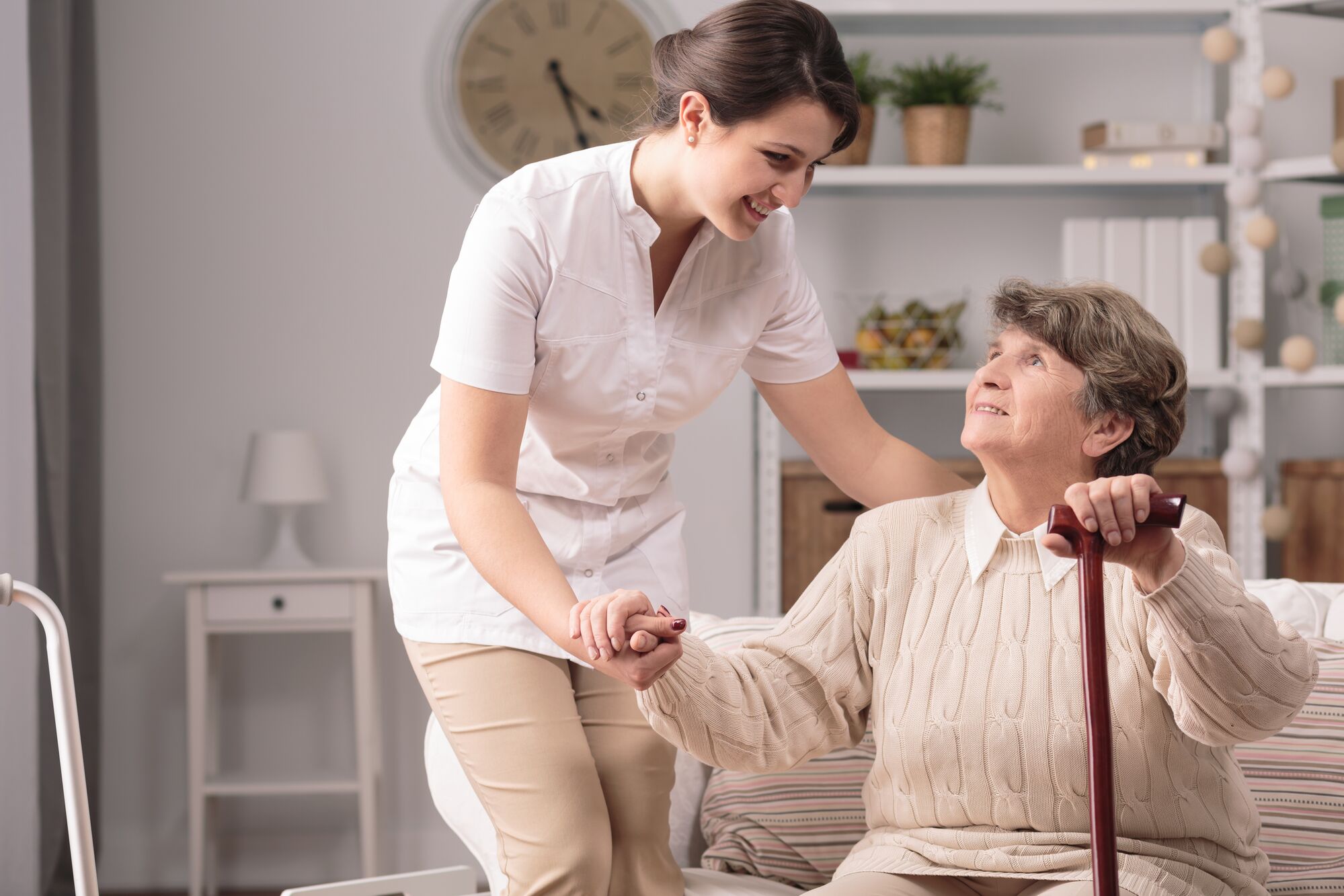 A care giver assisting an elderly woman